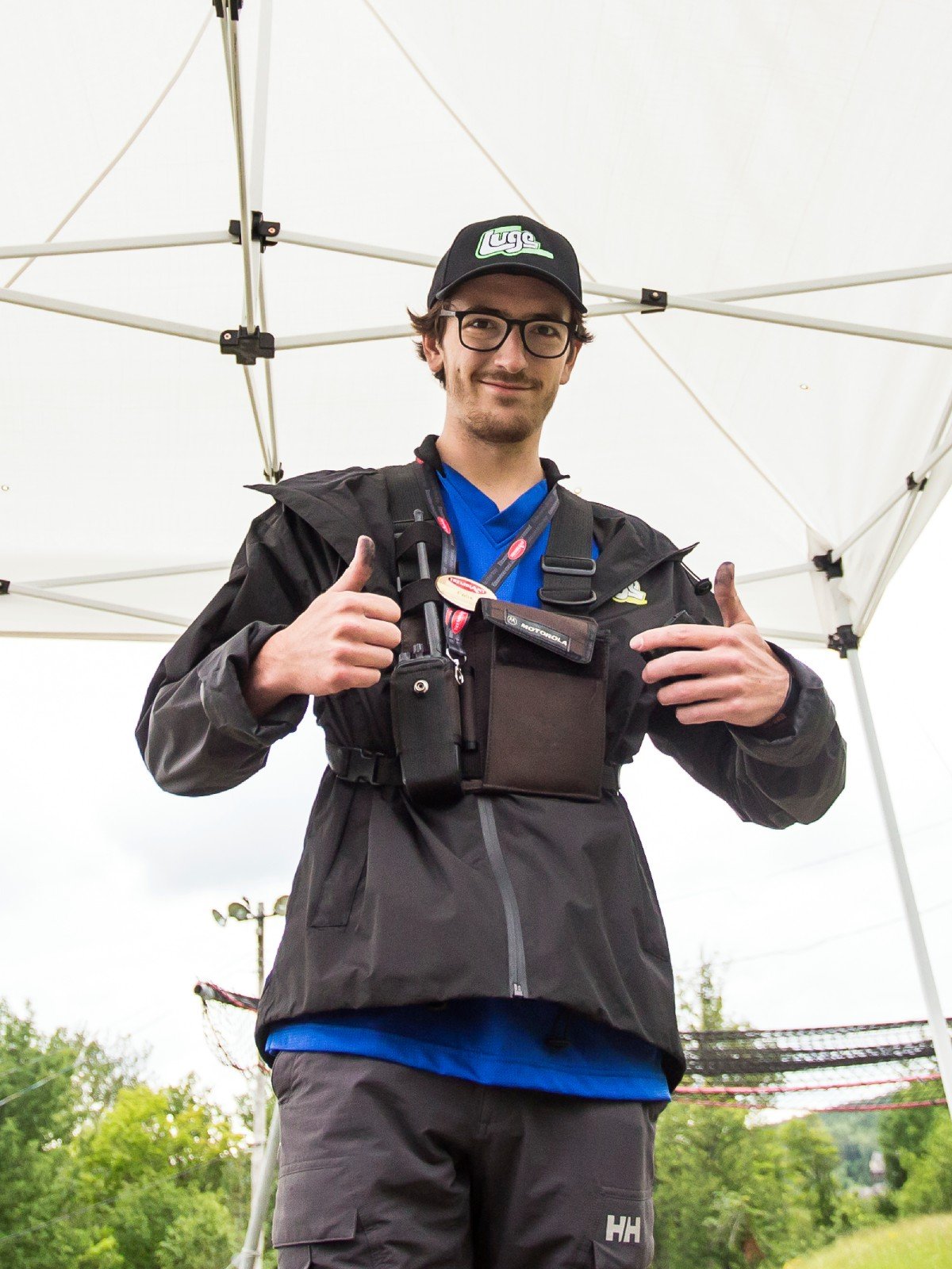 A Skyline Luge Mont Tremblant employee wearing a radio gives a thumbs up.