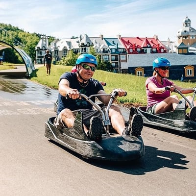 An older man races down the Luge towards the end of the tracks.