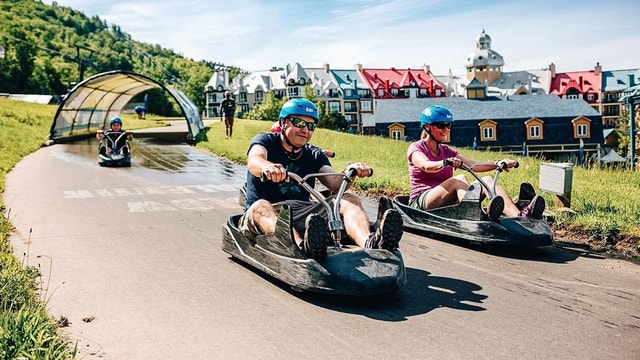 An older man races down the Luge towards the end of the tracks.